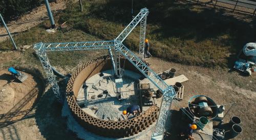 Circular building being 3d printed by robotics