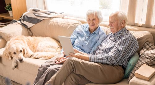 Two old people sitting at home