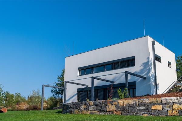 Modern, white, cube, elegant, minimalist style passive house with large panoramic windows, grey shutters in maintained garden