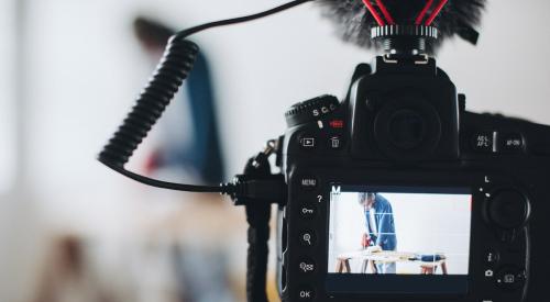 Camera on tripod recording builder with saw