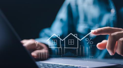 Someone types at laptop, in front of them is a diagram of a house with an upward arrow signaling increased costs