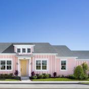 Pink exterior of Conch Collection Cottage (Alloha model) by Minto Communities