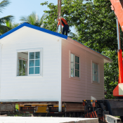 Manufactured home being craned into place on home site